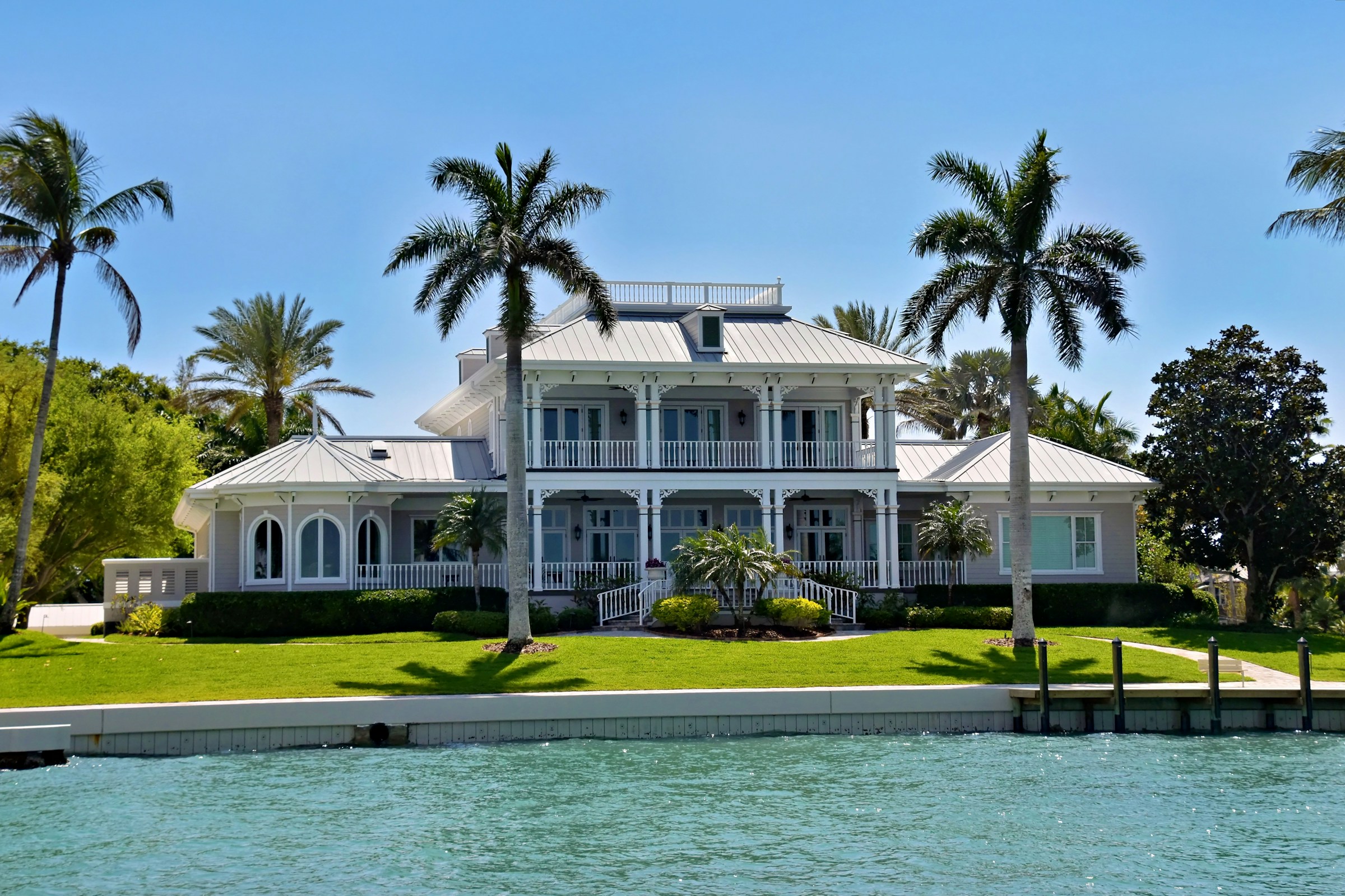 Beautiful coastal Florida home with palms overlooking turquoise water